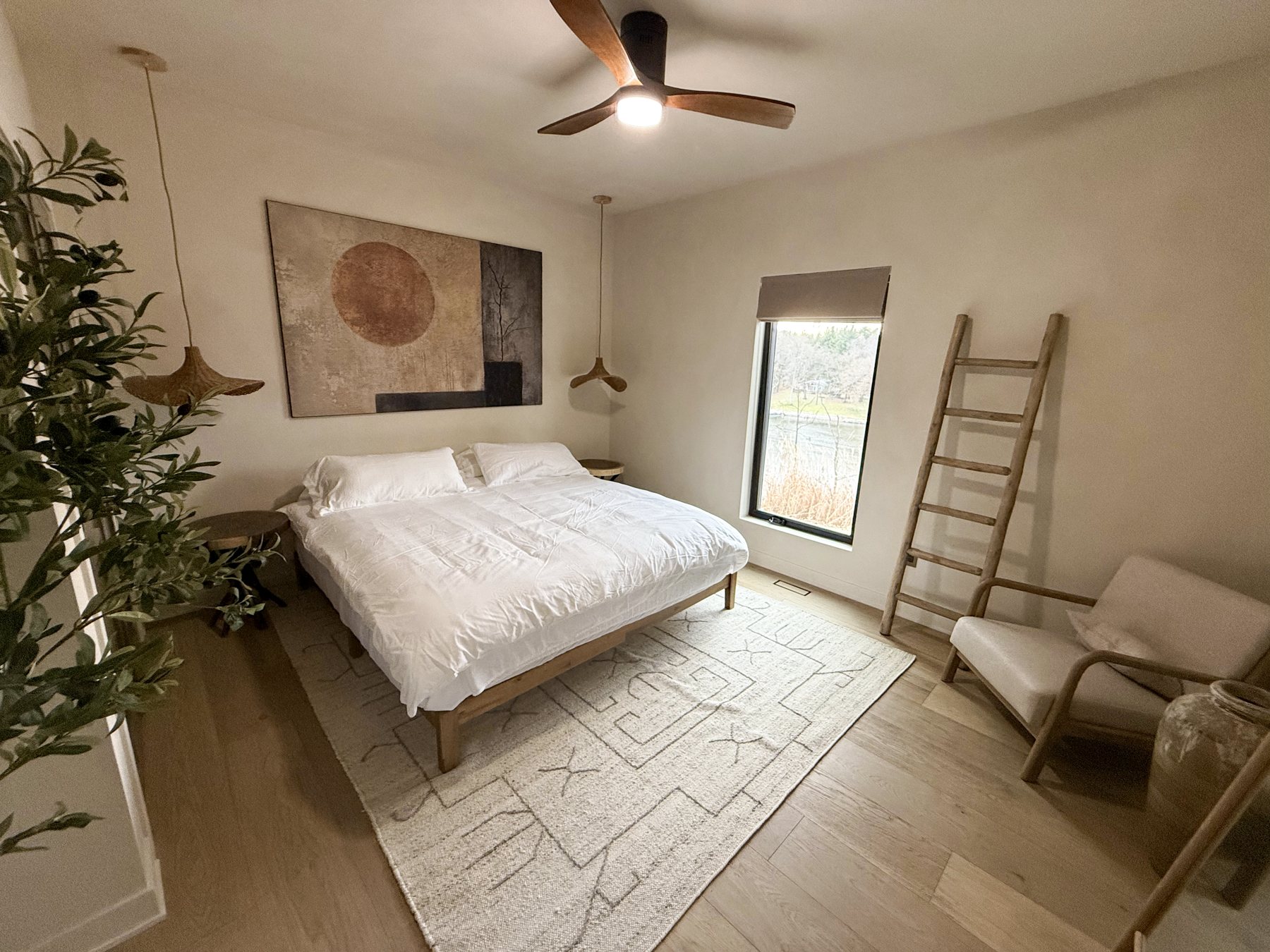 King bedroom with a picture window over the river