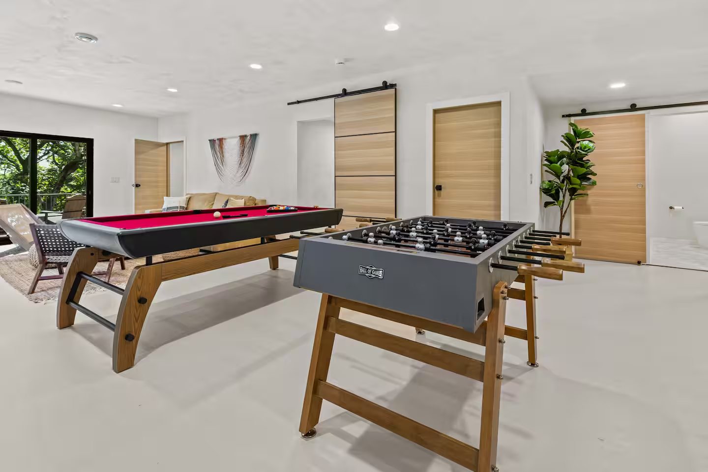 Game room with pool table and foosball